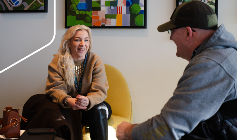 A photo of a man and woman sitting on chairs